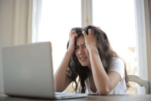 A woman dropped by her auto insurance company on a laptop