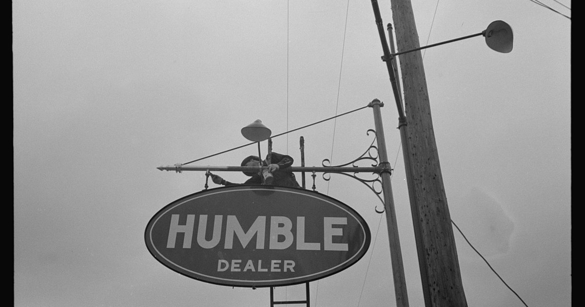 Man erecting sign near Alice, Texas